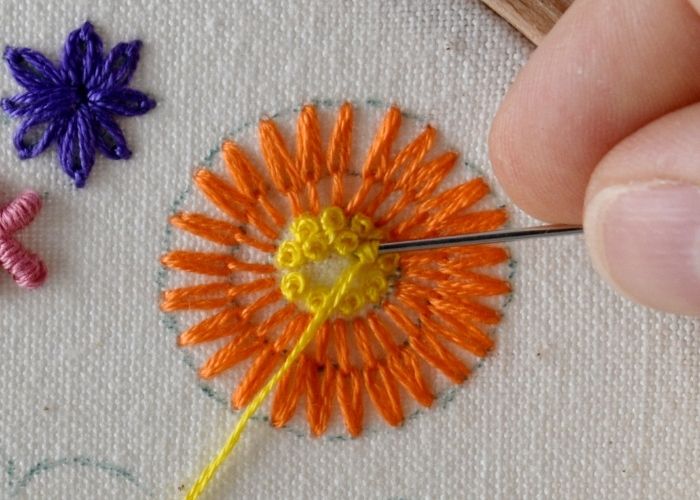 Filling the center of the flower with french knots